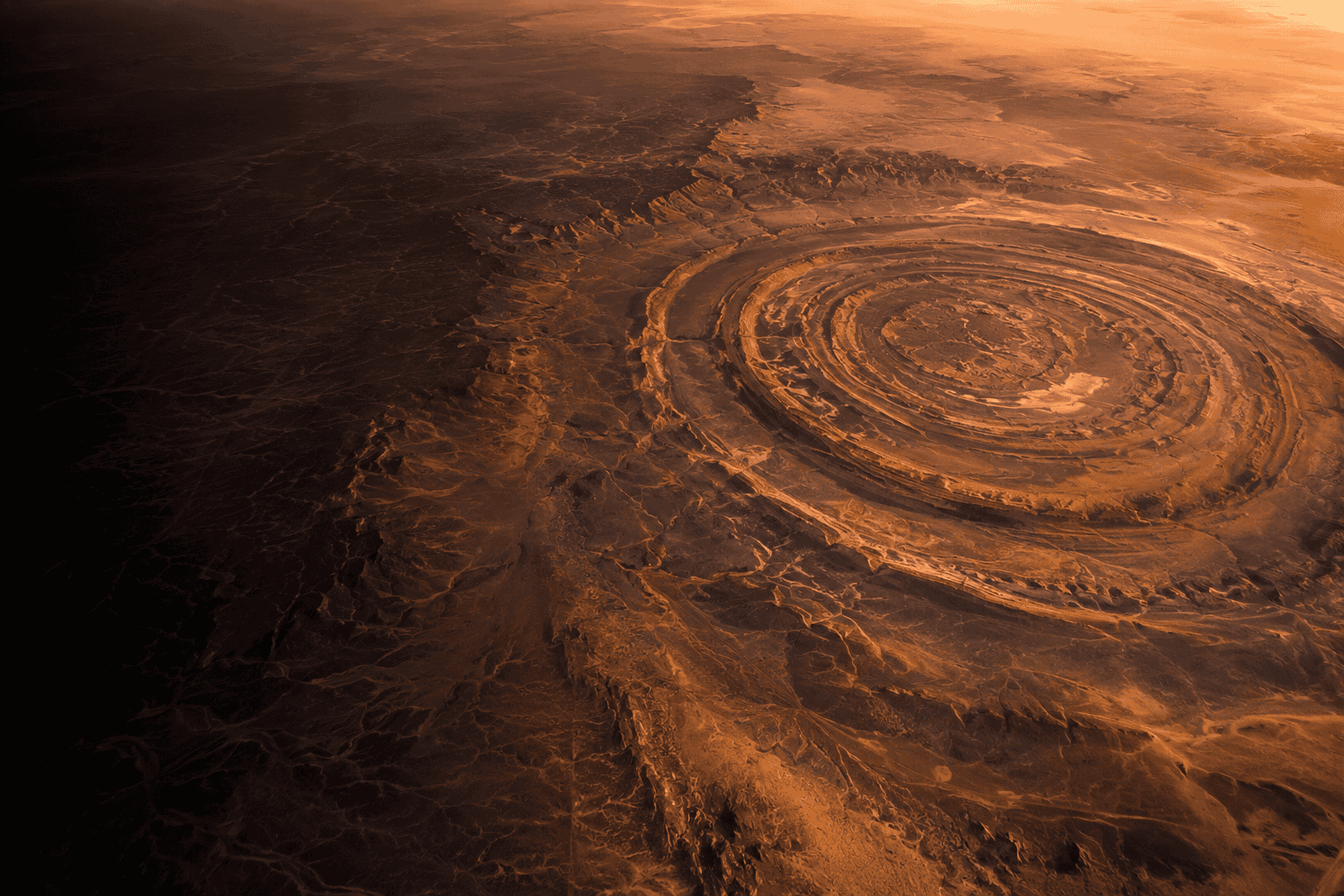 Richat Structure: aerial view of the Eye of Africa concentric ring formation in Mauritania at golden hour, identified as Plato's Atlantis location